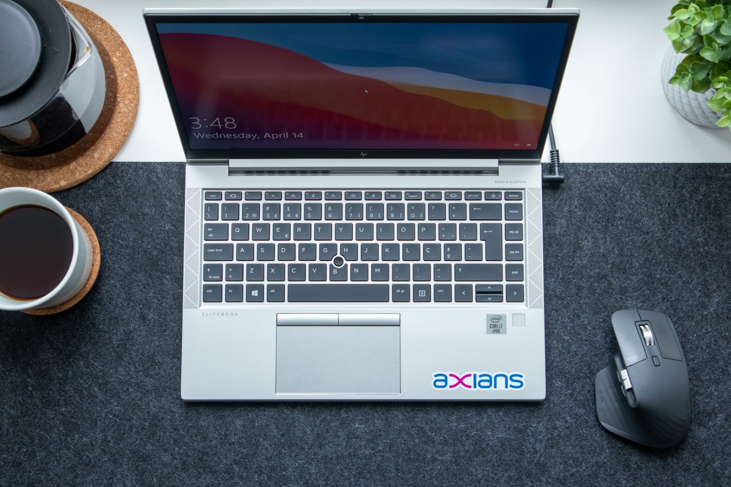 Open laptop and coffee on a modern desk workspace.